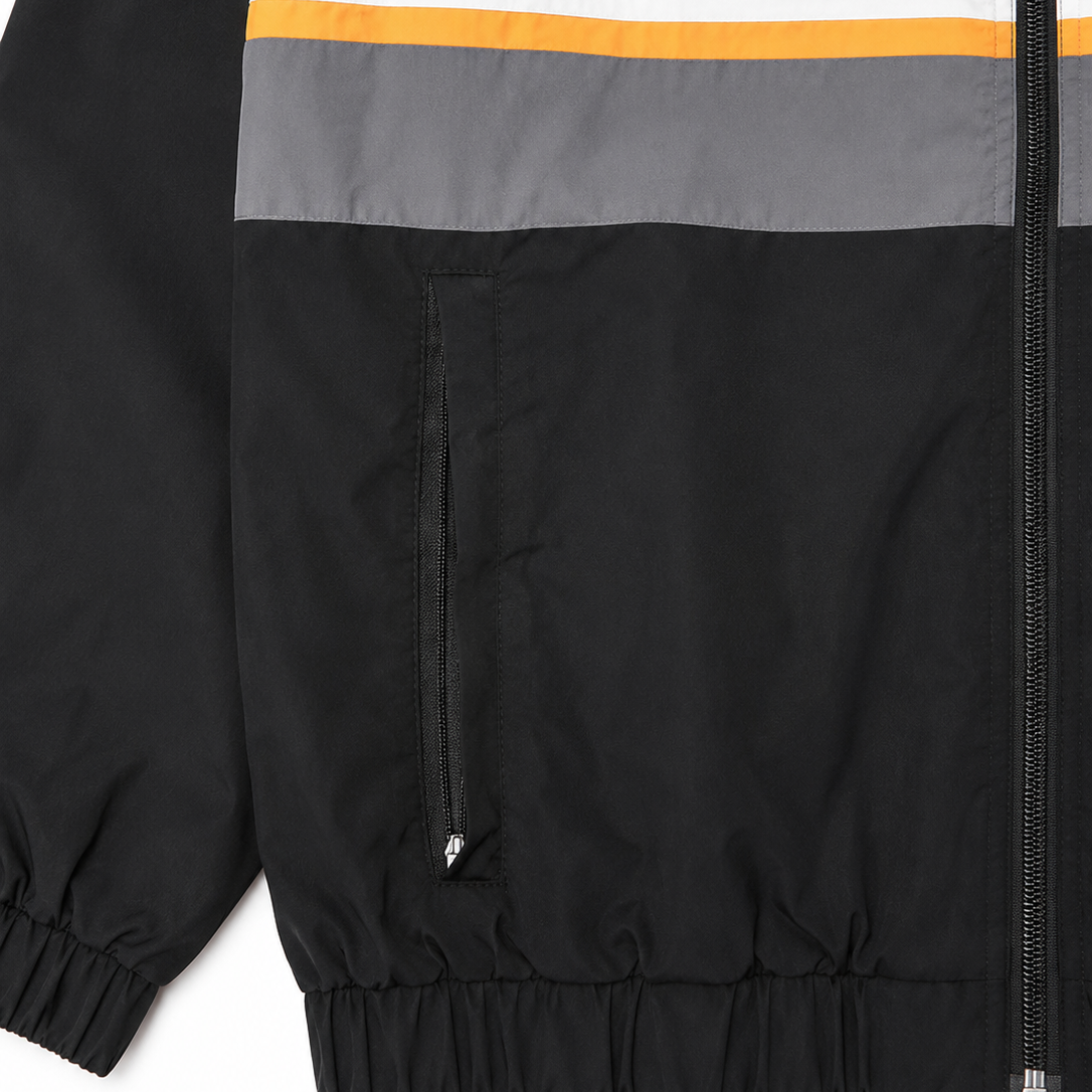 Close-up of a jacket with color-blocked design on a white background